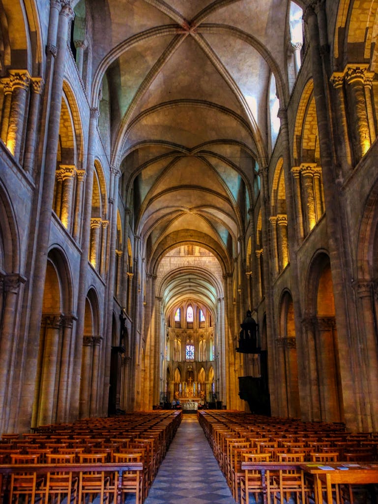 Beautiful architectural details of the Caen Cathedral interior showcasing gothic arches and nave.