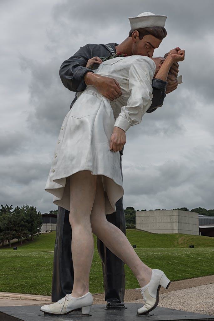 Statue of a sailor kissing a nurse in Caen, Normandy, symbolizing war remembrance.