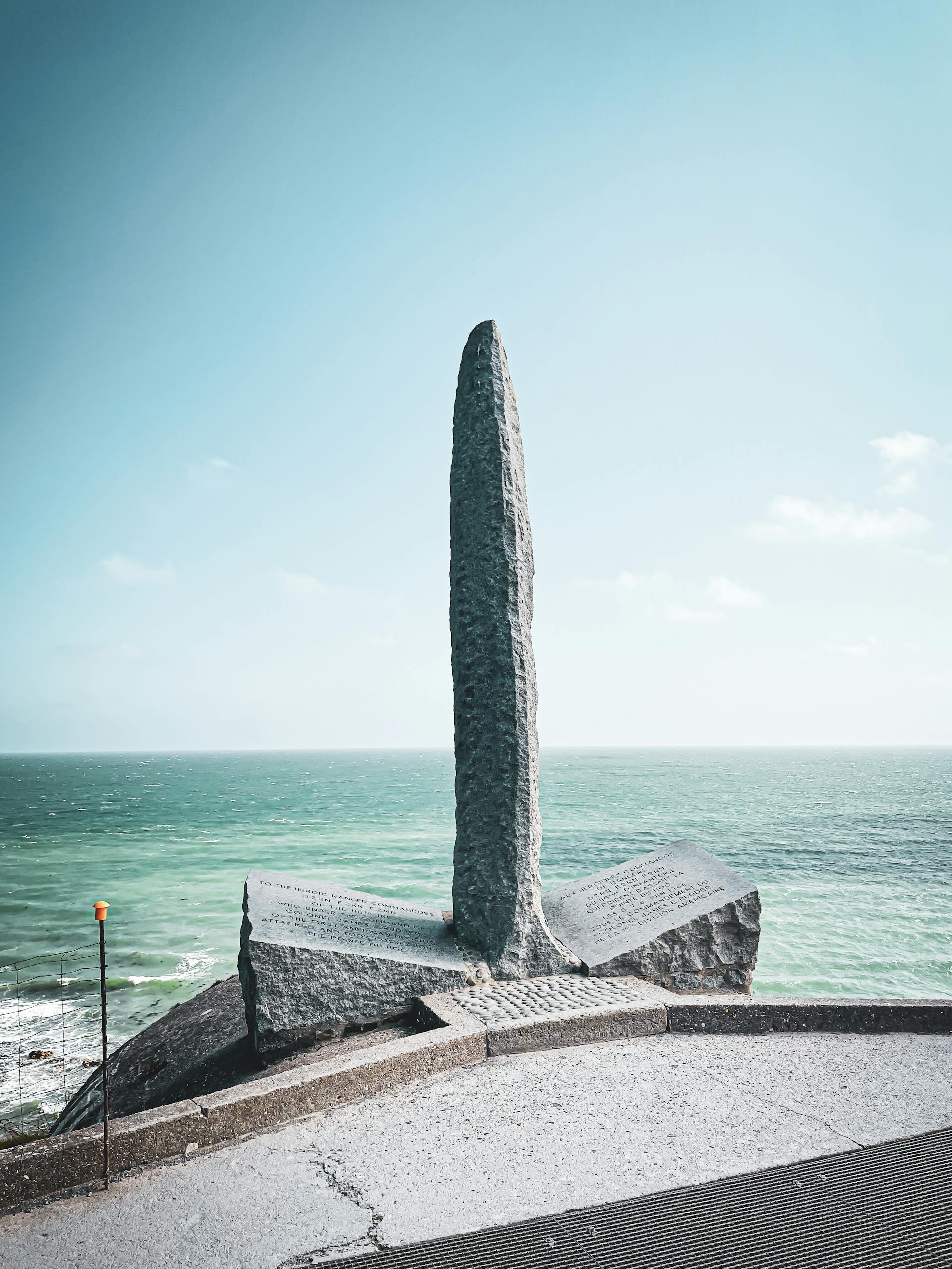 Historical World War II bunker located at Normandy, France with concrete fortification and gun turret.
